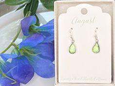 Beautiful light green crystal dangle earrings. Lovely and sparkly. Great gift for August birthday. Sterling silver hooks. These gorgeous earrings come in a gift box and an organza bag. They are ready to be given to that special someone. Great gift idea for a birthday, an anniversary, Valentine's Day or any occasion. Great for mothers, sisters, daughters or friends! What a great personalized gift! IF THIS IS A GIFT, PLEASE WRITE THE NOTE (TO, FROM, MESSAGE) IN THE CART AND I WILL SEND A SMALL CAR Green Drop Earrings For Birthday, Green Crystal May Birthstone Earrings For Gift, Green Crystal Earrings For May Birthstone Gift, Green Crystal Earrings For May Birthstone Anniversary, Lime Green Jewelry With Matching Earrings For Gift, Peridot Earrings For May Birthstone Gift, Faceted May Birthstone Earrings Gift, Peridot Lime Green Earrings For Gift, Peridot Lime Green Earrings As Gift