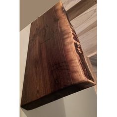 a piece of wood hanging from the side of a wall