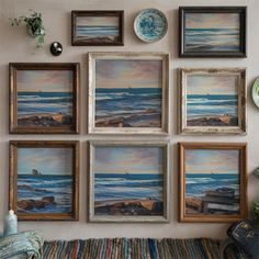 there are many framed pictures on the wall next to each other, including one with a beach scene