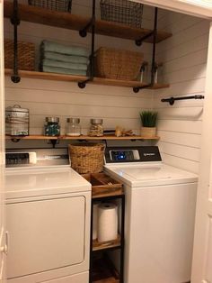 a washer and dryer in a small room with open shelving on the wall