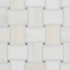 a white tile wall with grey and beige squares