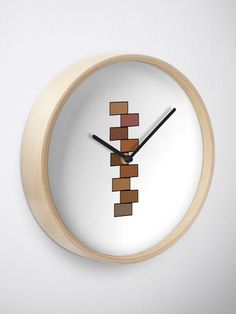 a clock that is made to look like a piece of wood with blocks on it