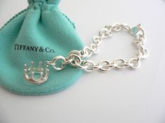 Offered
for sale is a wonderful Tiffany and Co. Sterling Silver Crown Charm
bracelet.   The piece is made from substantial and bright Tiffany
silver, and yet retains a very feminine feel to it.  Attached to its
very substantial Tiffany Silver charm bracelet is a fantastic and
whimsical Crown charm.  The charm is attached to the bracelet with a
Sterling Silver Tiffany Clasp - this clasp opens and closes and thus
can be used as a charm on a necklace or as part of another charm
bracelet! Super v Luxury Silver Chain Jewelry For Weddings, Luxury Sterling Silver Jubilee Bracelet As Gift, Luxury Sterling Silver Chain Bracelet As Gift, Luxury Chain Bracelets For Wedding, Designer Silver Chain Bracelet As Gift, Designer Silver Chain Bracelet For Gift, Designer Jewelry With Silver Chain For Gift, Luxury Silver Chain Bracelets, Luxury Sterling Silver Bracelet With Polished Finish For Gifts