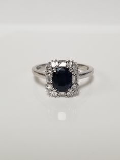 "Thanks for shopping our vintage estate store. We tend to sell well below wholesale and truly hope you enjoy all of our items. Many of the items are one of a kind, so please enjoy scrolling through the pictures and hopefully something will catch your eye. Beautiful vintage estate 14k white gold natural dark blue 1.5ct sapphire and .50ct diamonds. Gem is a dark sapphire, 2nd picture shows light behind gem, but sapphire is dark blue. Ring size: 9 Setting: 1/2\" Band width: 2mm Weight: 3.35 grams S Timeless Oval Sapphire Ring Vvs Clarity, Timeless Oval Sapphire Ring With Vvs Clarity, Classic Gia Certified Emerald Cut Sapphire Ring, Classic Sapphire Ring With Vvs Clarity Cushion Cut, Gia Certified Oval Diamond Ring For Anniversary, Classic Gia Certified Cluster Ring For Anniversary, Classic Hallmarked Diamond Halo Ring, Classic Oval Sapphire Ring, Classic Oval Sapphire Ring With Prong Setting