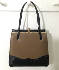 "1950s 1969s 2-Tone Spectator Handbag, Vintage Kelly Bag Top Handle Purse, Mid Century Accessory Classic 1950s 1960s 2-tone Spectator handbag in a milk chocolate and black. This vintage handbag features two black double handles/straps. There is a gold tone metal frame with a ball clasp closure that works well and closes tightly with that lovely \"snapping\" sound letting you know that everything inside is safe and secure. Opens to a dark brown fabric lining that is clean with no odors, stains or Vintage Satchel With Detachable Handle For Shopping, Vintage Top Handle Satchel For Shopping, Rectangular Retro Shoulder Bag For Vintage Events, Retro Leather Satchel For Evening, Retro Rectangular Shoulder Bag For Vintage Events, Vintage Brown Retro Bag For Formal Occasions, Retro Evening Satchel With Detachable Handle, Vintage Brown Retro Bags For Evening, Retro Satchel With Detachable Handle For Formal Use