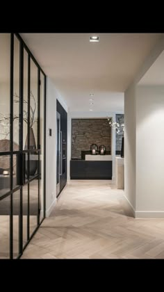 the hallway is clean and ready for guests to use it as an entrance way in this modern home