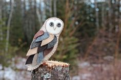 an owl sitting on top of a tree stump