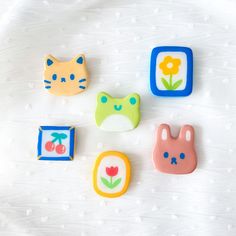 four different shaped cookies sitting on top of a white surface