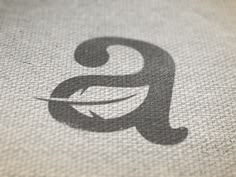 the letter g is inscribed in black on a white cloth with an arrow pointing to it