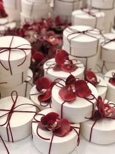 many white boxes with red flowers on them are tied together and placed next to each other