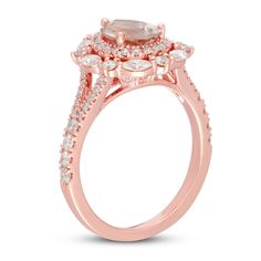 a rose gold engagement ring with an oval cut diamond surrounded by small white and light pink diamonds