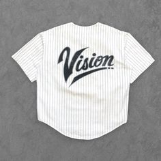 Vintage Vision Street Wear Baseball Jersey, 1980's Size Medium (fits Large) // 100% cotton, supersoft lightweight cotton twill, single-stitch construction, oversize fit, pinstripe design, full button front, Vision logo at left chest, oversize Vision logo at back, light marks throughout, overall excellent vintage condition.  Measurements: Chest 24", Front Length 27", Back Length 29", Sleeve Length 10" Sporty Cotton Tops With Vertical Stripes, Relaxed Fit Pinstripe Cotton Tops, Pinstripe Cotton Tops With Relaxed Fit, Classic Streetwear Tops With Three Stripes Branding, Classic Tops With Three Stripes Branding For Streetwear, Classic Three Stripes Tops For Streetwear, Retro Cotton Tops For Streetwear, Classic Pinstripe Cotton Top, Pinstripe Cotton Short Sleeve Top