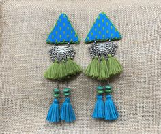 "Handmade item : Triangle shaped fabric ethnic pendant earrings with tassels. Length : Total length 6\" ( triangle ix 2 x 2 x 2\" ) approx. Closure : Push back Beautiful handcrafted ethnic fabric earrings with metal coin and tassels. These beautiful handcrafted earrings are comfortable to wear for any occasion. Maintenance tips: Avoid direct contact with deo's, perfumes and sprays. Keep the earrings packed and away from humidity when not in use. For fabric jewelry : https://www.etsy.com/shop/uDa Festive Latkans Earrings For Navratri, Festive Bohemian Green Danglers, Handmade Earrings Fabric, Traditional Handmade Tassel Earrings For Festive Occasions, Festive Bohemian Beaded Tassel Earrings, Festive Motif Earrings For Navratri, Traditional Blue Tassel Earrings For Festival, Fabric Jewelry Handmade, Traditional Tassel Earrings With Latkans For Festivals