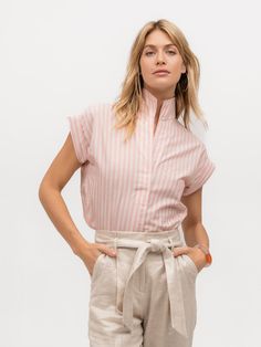 Woman wearing a luxury cap sleeve shirt with pink and cream stripes Summer Daywear Top With Striped Collar, Summer Top With Striped Collar, Striped Linen Tops For Work, Pink Short Sleeve Top With Striped Collar, Spring Striped Collared Top, Casual Pink Tops For Work, Spring Daywear Striped Tops, Spring Striped Tops For Daywear, Casual Pink Top With Striped Collar