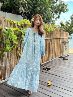 Introducing our Lola Bohemian Cotton Maxi Dress in Blue Limited Edition - an exceptionally unique piece available in limited quantities. The Lola's captivating design is meticulously handcrafted using wooden blocks meticulously placed on the finest cotton voile, resulting in a dreamy block printed pattern that draws inspiration from the bougainvillea flower and the essence of vacation. This dress exudes timeless femininity, boasting a maxi-length with an oversized style, making it a versatile ch Blue Cotton Boho Maxi Dress, Blue Cotton Boho Dress For Vacation, Blue Cotton Boho Dress With Floral Print, Blue Floral Cotton Boho Dress, Light Blue Cotton Bohemian Dress, Blue Floral Print Cotton Boho Dress, Bohemian Light Blue Cotton Maxi Dress, Blue Cotton Boho Dress With Block Print, V-neck Block Print Maxi Dress For Vacation