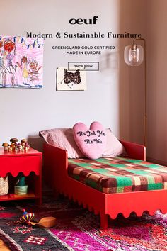 a bedroom with pink and green furniture in front of a wall mounted art piece on the wall