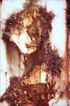 an abstract painting of a woman's face with brown and white paint on it