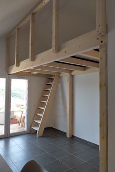 a loft bed with stairs to the second floor