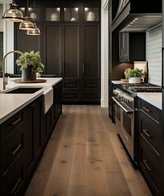 a kitchen with dark wood cabinets and white counter tops, along with wooden flooring