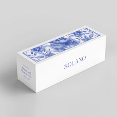 a white box with blue and white designs on the lid that says solanoo