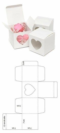 an open box with hearts cut out from it and the inside is shown in white paper