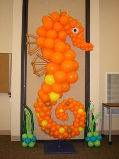 an orange balloon seahorse is on display