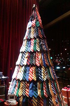 a christmas tree made out of ties in a room