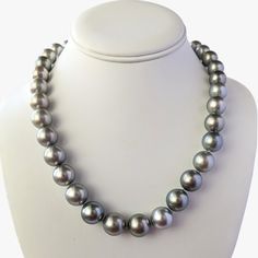 Experience the timeless elegance, crafted with exceptional quality and beauty. The necklace features lustrous Tahitian pearls of various sizes, ranging from 11 to 15 mm, and is finished with an 18K Rhodium-plated white gold and diamond clasp that adds a touch of luxury to the piece. The clasp contains 56 round brilliant cut diamonds (NC/SI) with a total weight of 1.23ct. The pearls showcase a silvery gray color pearls that exudes sophistication and refinement, with a uniformity that creates a harmonious appearance. Each pearl is carefully selected for its exceptional quality and luster, with a high shine and round shape that enhance the necklace's overall elegance. The necklace's length of 19 inches makes it versatile, pairing effortlessly with most necklines, and the weight of 99 grams pr Tahitian Pearl Necklace, Pearl Clasp, Tahitian Pearls, Small Jewelry, Pearl Size, Round Brilliant Cut Diamond, Cultured Pearls, Round Brilliant Cut, Brilliant Cut Diamond