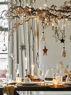 Christmas lighting ideas: hanging lights Christmas Branches, Christmas Dining Table, Christmas Lighting, Christmas Hanging Decorations, Branch Decor, Christmas Dining, Christmas Decorations Rustic, Ceiling Decor, Tree Branch