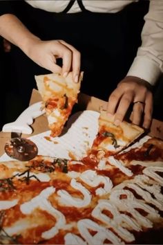 a man is cutting into a large piece of pizza