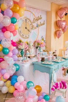 a birthday party with balloons, cake and decorations