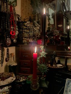 a candle is lit in the middle of a room filled with jewelry and other items