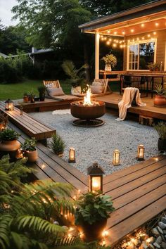 an outdoor patio with lights on the deck and potted plants in the back yard