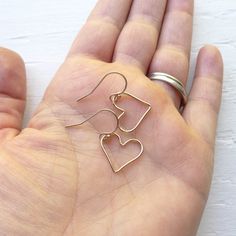 "Sweet \"floating\" rose gold filled wire hearts dangle from rose gold filled hook earwires to create these dainty irresistible earrings. The hearts measure just over 1/2\" from top to bottom. . { p a c k a g i n g } . Your jewelry will arrive in a cute box - perfect for giving or keeping for yourself. . { s h i p p i n g } . Handmade in my studio and shipped via USPS First-Class mail with tracking. Please see shipping & policies tab above for current production times. International buyers p Cheap Handmade Dangle Heart Earrings, Rose Gold Earrings For Everyday Valentine's Day, Rose Gold Earrings For Valentine's Day, Rose Gold Earrings For Everyday And Valentine's Day, Rose Gold Heart Charm Earrings For Everyday, Everyday Rose Gold Heart Charm Earrings, Everyday Rose Gold Heart Earrings With Charm, Minimalist Nickel-free Dangle Heart Earrings, Dainty Hypoallergenic Heart Drop Earrings