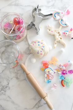 the cookie cutters are next to some cupcake decorating supplies on a marble surface