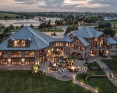 an aerial view of a large house with lots of windows and lights on the roof