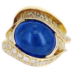 A 10.48 ct. Sapphire Cabochon and 0.54 ct. Diamond Cocktail Ring made in 18 Karat Yellow Gold. Ring Size US 6.50. The total weight is 12.60 grams. Sapphire Cabochon, Diamond Cocktail Ring, Diamond Cocktail Rings, Yellow Gold Ring, Cocktail Ring, Cocktail Rings, Gold Ring, Jewelry Rings, Sapphire