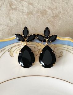 Gorgeous pair of earrings featuring 18x13mm teardrops and 10x5mm marquise Swarovski crystals in jet black.  1 1/4 inches long. Shown in the gold metal finish.  Post backs for pierced ears. Black Crystal Chandelier Earrings, Black Crystal Earrings For Wedding, Black Teardrop Crystal Earrings For Formal Events, Black Teardrop Earrings For Evening, Formal Black Teardrop Crystal Earrings, Black Earrings Elegant, Black And Gold Earrings, Earrings Chandelier, Golden Earrings