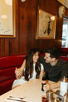 a man and woman sitting at a table in a restaurant