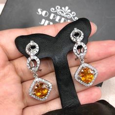 STUNNING 6.17 Total Carats, VIVID orange sapphires and 1.12 carats of F/VS, natural diamonds, set in handmade 12 grams, 18K solid white gold dangling, earrings, with secured omega, latch back. Easy to wear, and comfortable. With natural sapphires and sparkling diamonds, set in one of a kind, 18K Solid white gold, dangling earrings. ONE OF A KIND HANDCRAFTED EARRINGS. IN CASE OF RETURN FOR US BUYERS. BUYERS MAY SEND THE ITEMS BACK TO OUR US-BASED OFFICE IN SALT LAKE CITY, UTAH Our jewelry are spe Orange Dangle Earrings For Formal Occasions, Orange Earrings For Anniversary In Fine Jewelry Style, Orange Drop Earrings For Formal Occasions, Orange Cubic Zirconia Jewelry For Anniversary, Orange Drop Earrings For Anniversary, White Gold Topaz Gemstone Earrings, Orange Fine Jewelry With Matching Earrings, Fine Jewelry With Orange Cubic Zirconia, Fine Jewelry In Orange Sterling Silver