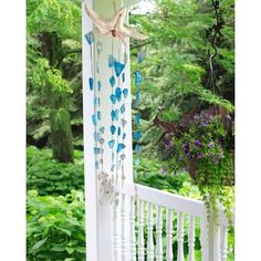 a white porch with blue butterflies hanging from it