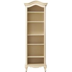 a white bookcase with three shelves on each side and one door open to the other