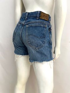 "Vintage 80's Lee Riders USA, Cut Off, Jean Shorts (W30) These 1980's Lee Riders cut off's come in a medium wash cotton with a YKK metal zipper and button front closure with the signature leather Lee logo tab and frayed bottom leg opening edges. The denim is medium weight and without stretch.  100% Cotton Made in USA *These shorts are in excellent condition.  *Free shipping within the US. Size: Men's  (W30) Women's (M) Modern Day 6 (Tag Size: 31x30) Waist: 30\"  Hips: 36\" Inseam: 4\" Rise: 11\" (front) 13\" (back) Leg Opening: 10 1/2\" Weight: 1 pound 4 oz *Follow Freshandswanky on Instagram" Retro Cotton Cutoff Shorts, Retro Cotton Jean Shorts With Frayed Hem, Retro Style Medium Wash Cotton Jean Shorts, Retro Medium Wash Cotton Jean Shorts, Retro Cotton Jean Shorts In Medium Wash, Retro Cotton Shorts With Frayed Hem, Vintage Distressed Cutoff Bottoms, Retro Cutoff Bottoms With Frayed Hem, Vintage Medium Wash Cotton Bottoms