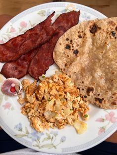 a plate with eggs, bacon and bread on it