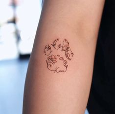 a person with a tattoo on their arm that has cats and dogs in the center