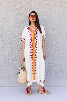 "This beautiful free size Kaftan has a unique presence to it. It's colorful and most importantly comfortable wear, light and soft and can be used on many occasions - home gatherings, dinners, or just in your home to feel comfortable. Fabric : 80% Egyptian Cotton and 20% Polyester Measurements : Free size. Fits up to 4XL. Also there is a belt that can be used to tighten the dress around the hips. Bust size : 67 inches Length : 57 inches **Note : The kaftan in the video is a different color of the White V-neck Kaftan For Spring, Traditional White V-neck Maxi Dress, White V-neck Embroidered Dress For Festival, Spring Vacation Kaftan With Resham Embroidery, White Resham Embroidery Dress For Festival, White Beach Dress With Geometric Embroidery, Bohemian Kaftan With Chikankari Embroidery For Summer, Bohemian Cotton Kaftan With Embroidered Border, Traditional White Short Sleeve Tunic