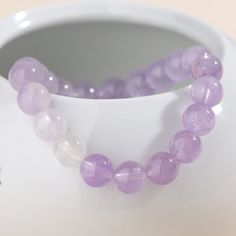 Grace lavender amethyst bracelet with changing color. Healing Lavender Crystal Bracelet With Gemstones, Lavender Crystal Bracelet With Adjustable Fit, Adjustable Lavender Crystal Bracelet, Lavender Amethyst Crystal Bracelet As Gift, Lavender Amethyst Bracelets With Natural Stones, Purple Amethyst Bracelets, Lavender Round Bracelet For Healing, Round Amethyst Purple Bracelets, Round Purple Amethyst Bracelets