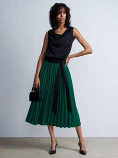 Pleated High Rise Midi Skirt | NY&Co Chic Green Pleated Skirt, Chic Green Lined Pleated Skirt, Chic Green Pleated Lined Skirt, Chic Green Pleated Workwear Skirt, Chic Green Pleated Skirt For Work, Chic Green Midi Pleated Skirt, Chic Green Pleated Maxi Skirt, Chic Green Flowy Pleated Skirt, Chic Asymmetrical Lined Pleated Skirt