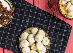 two bowls filled with food sitting on top of a table