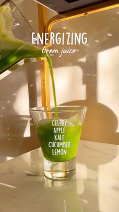 a green juice being poured into a glass with the words energizing written on it